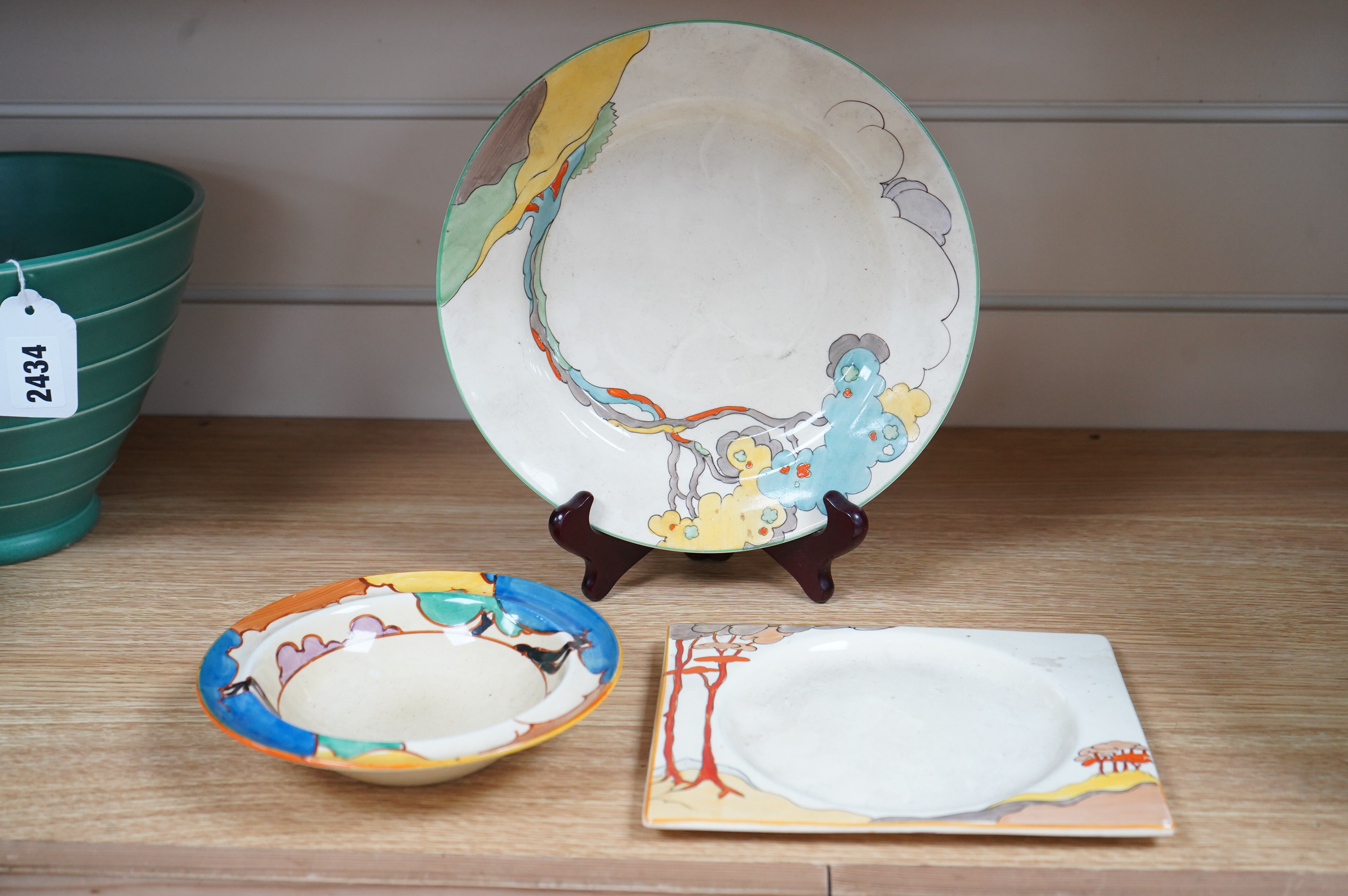 An early 20th century Clarice Cliff Bermuda pattern plate, Blue Autumn bowl and a Coral Firs Bizarre side plate, largest 23cm in diameter
